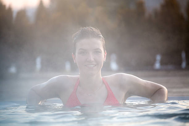 istock Young woman relaxing in thermal pool. 467849754