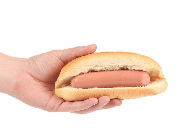 Hot dog with sausage roll in hand.