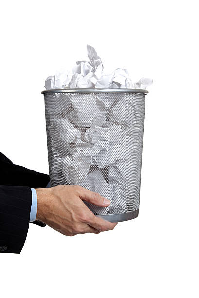 istock Business man holding full trash can 467853924