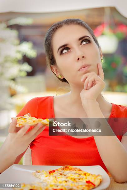 Young Woman Thinking About Eating Pizza On A Diet Stock Photo - Download Image Now - 2015, Adult, Choice