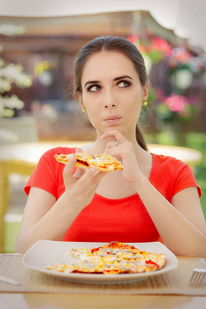 istock Young Woman Thinking About Eating Pizza on a Diet 467854108