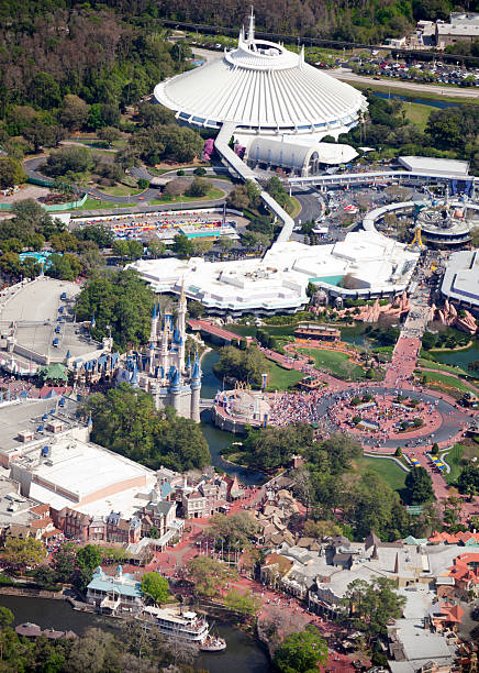 Aerial view of Walt Disney World's Magic Kingdom Lake Buena Vista, Florida, USA - Feb 28, 2011: Aerial view of Walt Disney World's Magic Kingdom, in Lake Buena Vista, Florida. Tourists are shown enjoying a beautiful day at the theme park. Cinderella's castle (center left) , Tomorrowland 's Space Mountain (top center) and Frountierland with Mark Twain's riverboat ride at the bottom. disney world stock pictures, royalty-free photos & images