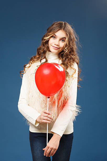 istock Young cute girl with heart-shaped ballon 467854633