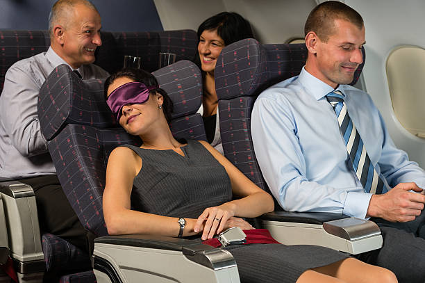 istock Business woman sleep during flight airplane cabin 467854953