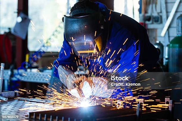 Welder Welding Metal In Workshop With Sparks Stock Photo - Download Image Now - Welder, Welding, Welding Torch