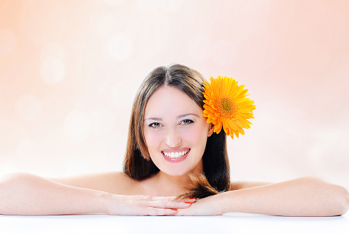 Portrait of young beatiful brunette in studio shot expressing positivity with perfect skin and body consciousness. One young woman posing in studio for healthy lifestyle concept, with perfect smile and teeth. Image developed from RAW file