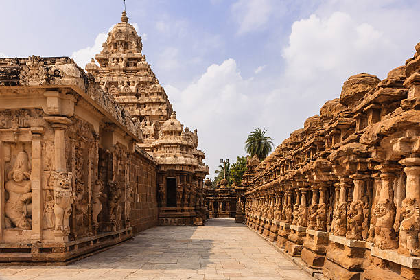 Kanchipuram, India - The Circumambulatory Passage At The 1300 Year Old Kailasanathar Hindu Temple. Built on the banks of the Vedavathi River, the Kailasanathar Temple is the oldest structure in in the Tamil Nadu city of Kanchipuram in South India. Built by the Pallava King Rajasimha also known as Narasimhavarman II, in the Dravidian style of architecture, Carved and sculpted mostly out of sandstone, it was built between 685 and 705 AD; it is dedicated to the god Shiva. Photo of circumbulatory passage shot in the afternoon sunlight. The outer wall can be seen to the right; each of the sections houses a shrine - 58 in total. Over the centuries, the wall leans towards the outside. Horizontal format; no people. Copy Space. phoenix stone stock pictures, royalty-free photos & images