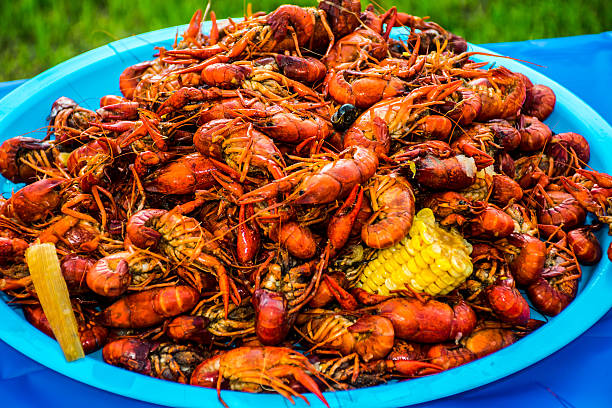 Crayfish Corn Potatoes Shell Fish Piled High Cajun Crawfish Bowl Crayfish Corn Potatoes Shell Fish Piled High Cajun Crawfish Bowl seafood boil spices stock pictures, royalty-free photos & images