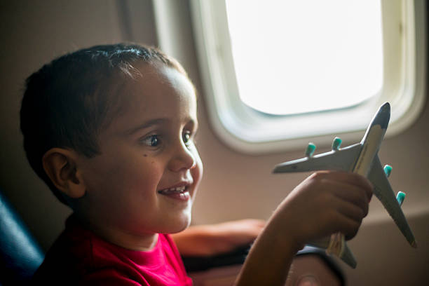 istock Young boy playing with toy airplane 467863390
