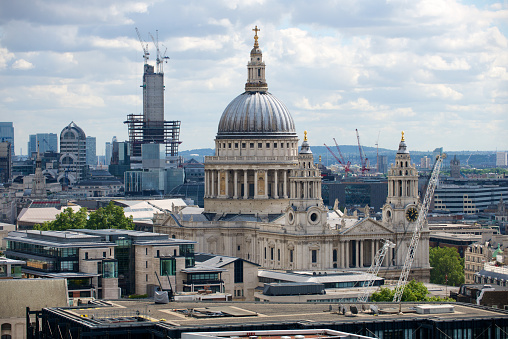 The iconic dome of St. Paul’s Cathedral overlooking the landmarks along the River Thames in the heart of London, UK.