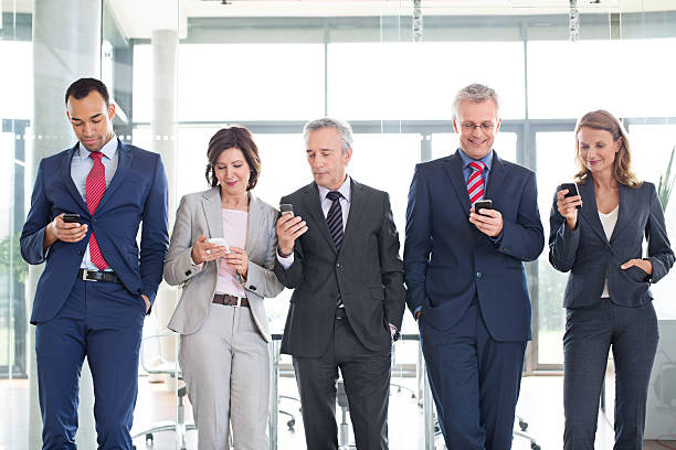 istock Group of corporate professionals using mobile phone 467867418