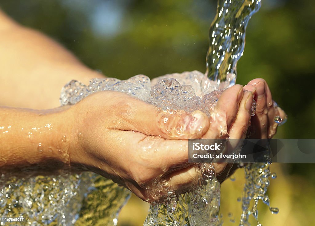 Woman's hands with water splash Adult Stock Photo