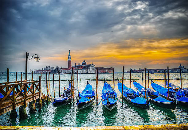 istock blue gondolas by the shore in Venice 467870378