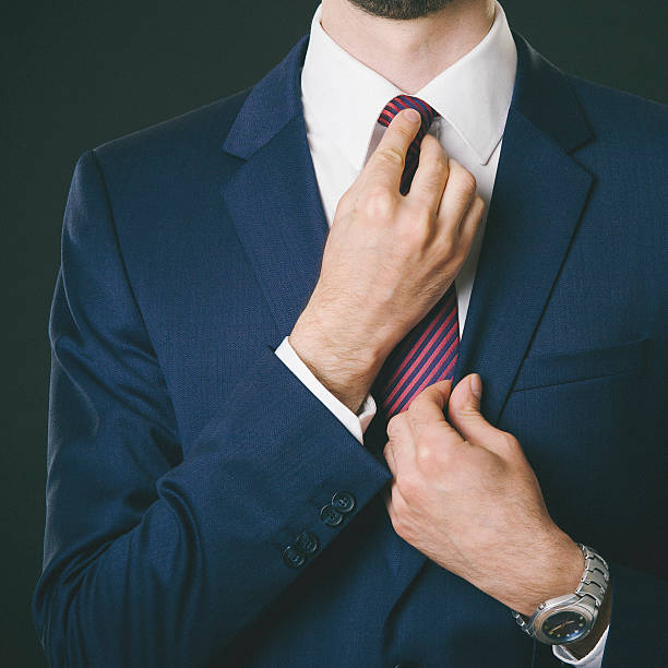 istock Young businessman tieing a tie 467870650