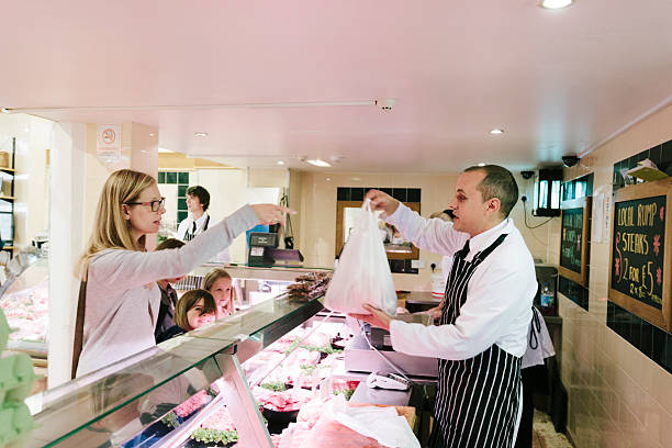Serving a customer, traditional British Butcher's shop