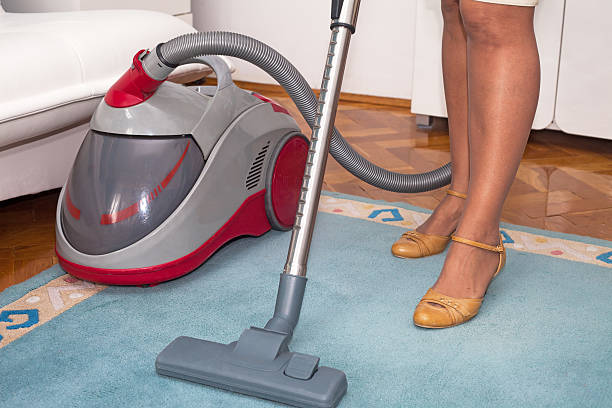 istock Housewife with vacuum cleaner 467874746