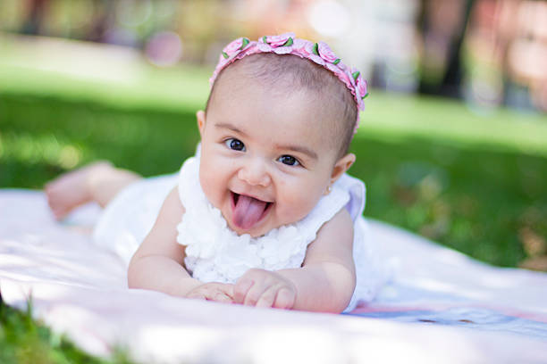 Happy baby girl looking at camera stock photo