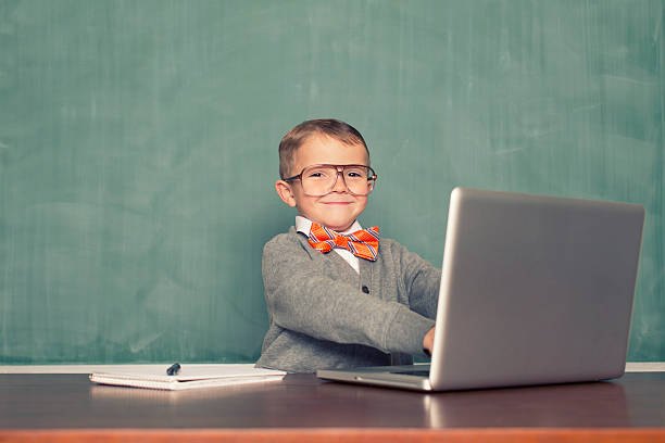 Little Blogger A young nerd is updating his blog. bow tie photos stock pictures, royalty-free photos & images