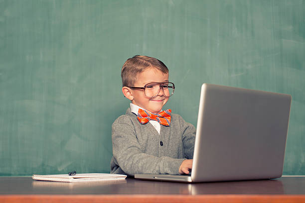 Computer Time A young nerd is updating his blog. nerd kid stock pictures, royalty-free photos & images