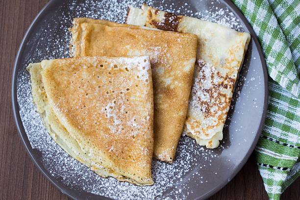 Thin sweet pancakes with powdered sugar for Breakfast, Shrovetide stock photo