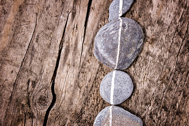 Lign of stones on a wooden background