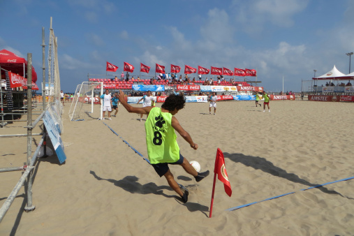 Valencia, Spain - July 8, 2012: A beach soccer player takes a corner kick during the \