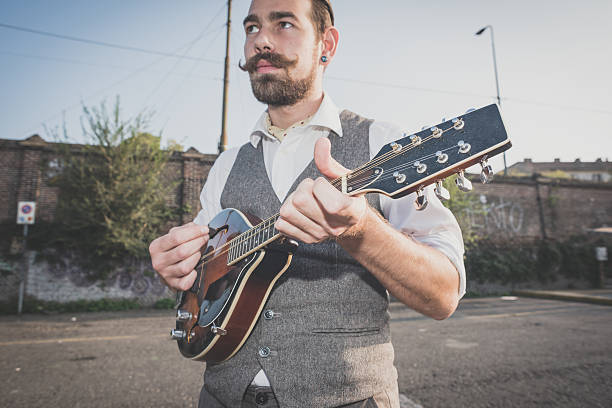 istock handsome big moustache hipster man playing mandolin 467881678