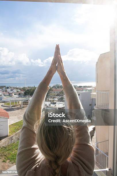 Woman Practices Yoga Moves Above Village Sea Stock Photo - Download Image Now - Republic Of Cyprus, Women, Yoga