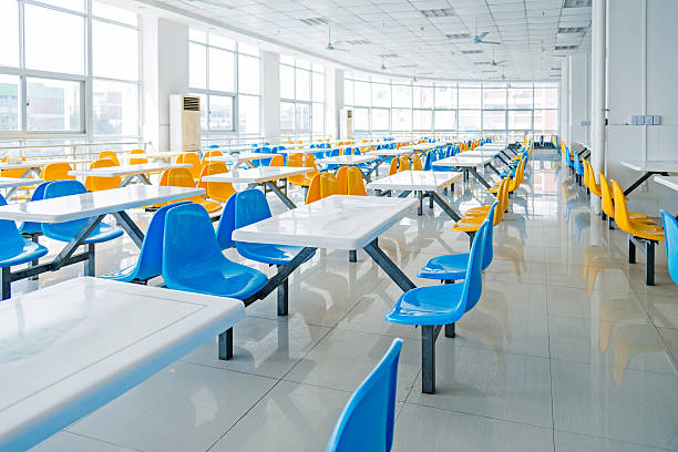 Empty school cafeteria Clean school cafeteria with many empty seats and tables. cafeteria stock pictures, royalty-free photos & images