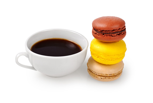 Cup of coffee and macarons isolated on white background.