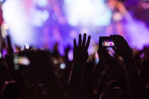 istock People taking photographs with touch smart phone during a music 467882852