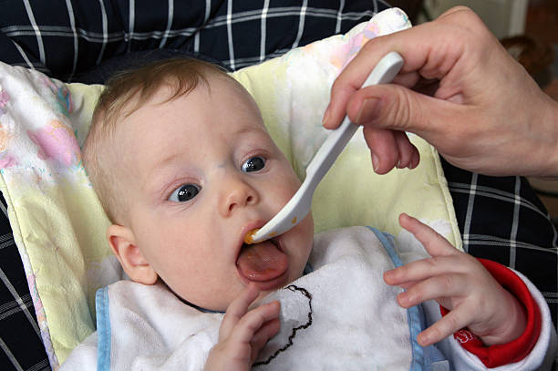 istock Baby eating first food 467884915