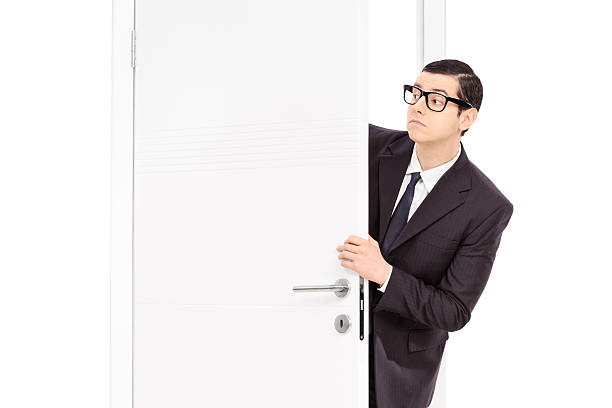 istock Businessman peeking through an opened door 467885272