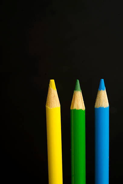istock yellow, green and blue coloured pencil crayons 467885911