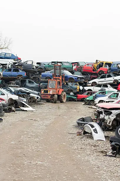 Piled up destroyed cars in the junkyard.