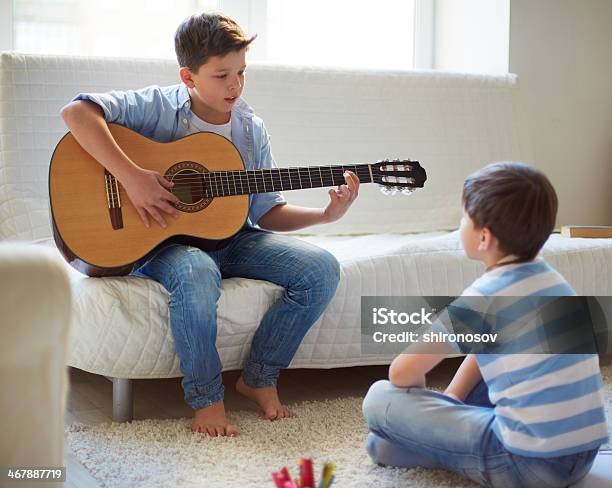 Learning How To Play The Guitar Stock Photo - Download Image Now - Brother, Child, Music