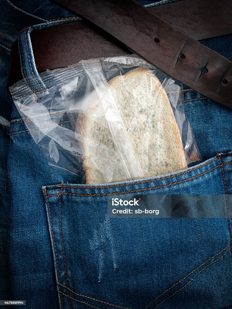 Pocket lunch Packed moldy slice of bread in the pocket. 2015 Stock Photo