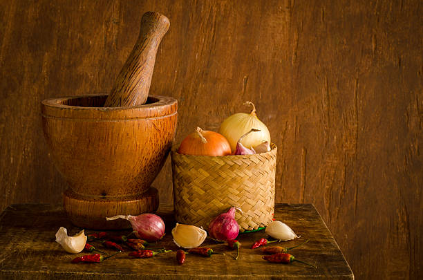 Wood mortar and many spices on table in kitchen,Still life