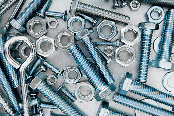 istock Fixing elements. Nuts, washers and bolts on scratched metal background 467895192