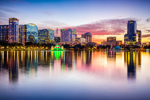Orlando Florida Skyline in the evening during Summer Orlando, Florida, USA downtown city skyline from Eola Park. orlando florida stock pictures, royalty-free photos & images