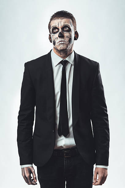 istock Sad businessman with makeup skeleton 467898500