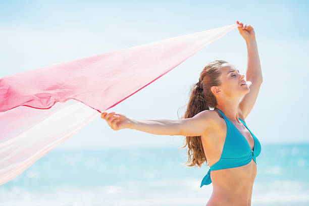 istock happy young woman with parero rejoicing on beach 467899025