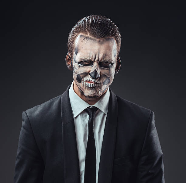 istock incredulous businessman with makeup skeleton 467899090