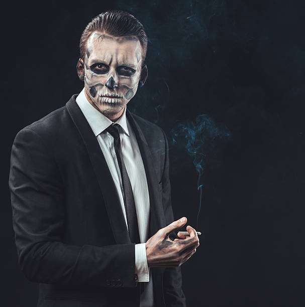 istock portrait businessman smoking with makeup skeleton 467899112