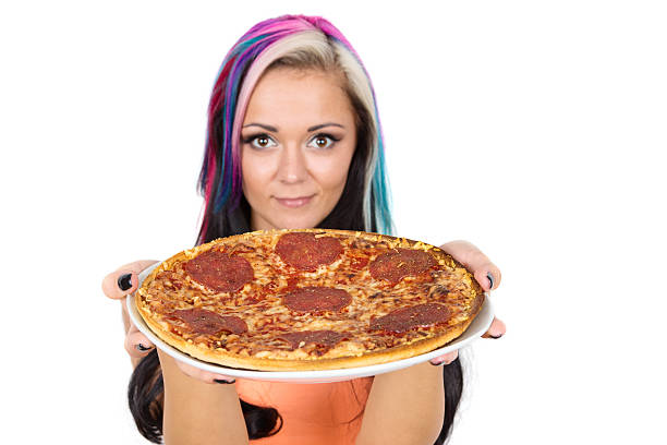 istock young woman with pizza 467901192