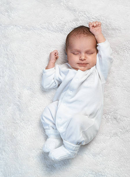 istock newborn stretches on  white fur 467901664