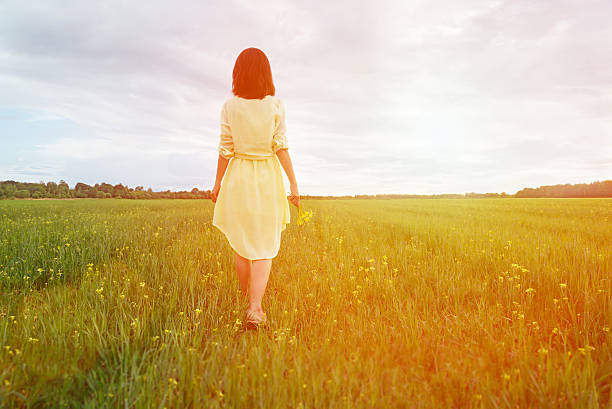 istock Woman walking on summer meadow 467902168