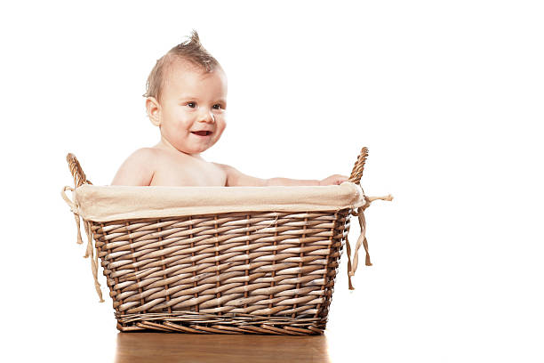 istock Happy little baby boy sitting in a wicker basket 467903444