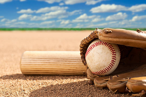 istock Baseball, glove and bat on field 467905033