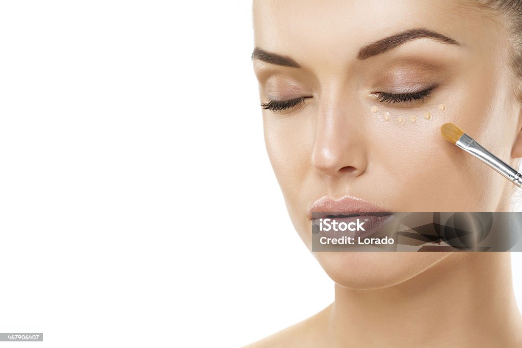 close up of woman applying foundation Adolescence Stock Photo